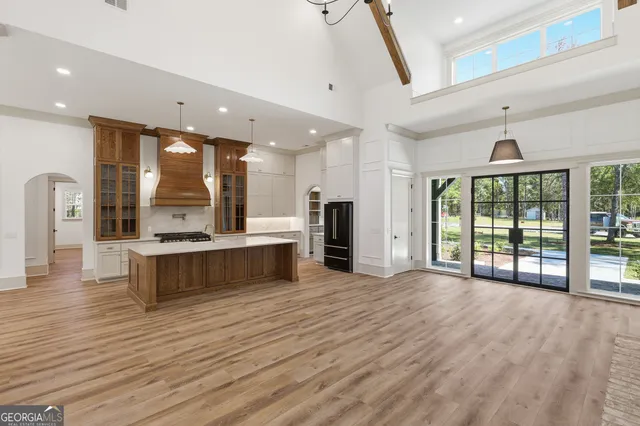 a kitchen with granite countertop a stove and a white cabinets