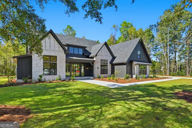a view of a house with a small yard