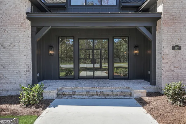 wooden floor fireplace and windows in an empty room