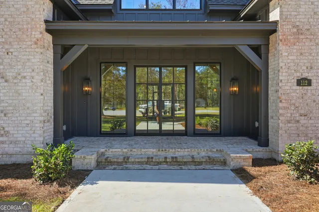 a view of empty room with wooden floor and fireplace