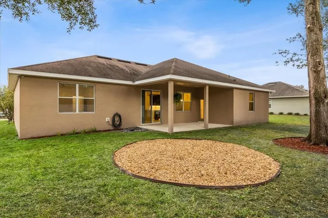 a view of a house with a backyard