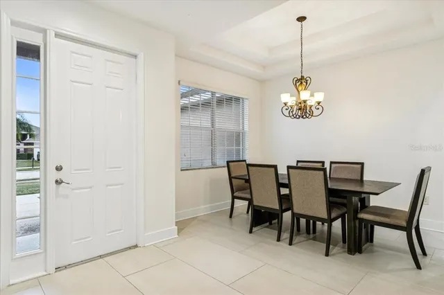 a view of a dining room with furniture and chandelier