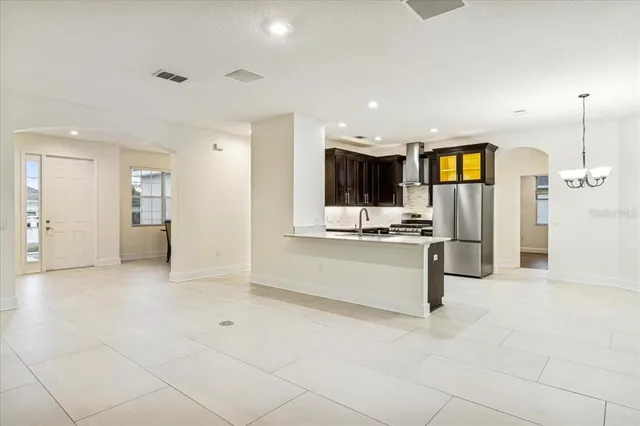 a view of kitchen with refrigerator and window