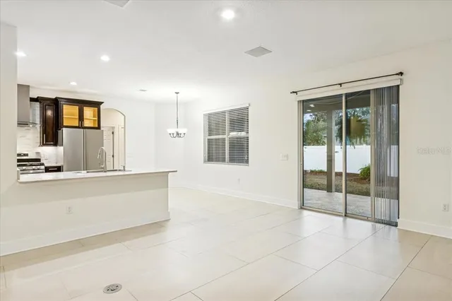 a view of an empty room with window and bathroom