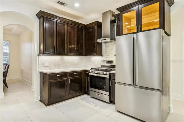 a kitchen with stainless steel appliances granite countertop a refrigerator and a stove