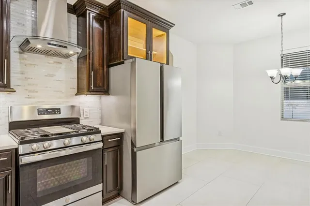a kitchen with stainless steel appliances a refrigerator and a stove