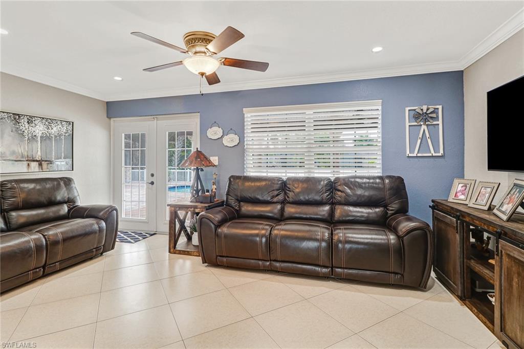 2329 41st Terrace Southwest Naples, FL 34116 - Photo 12 of 33 a living room with furniture and a flat screen tv