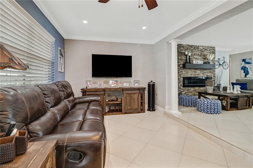 2329 41st Terrace Southwest Naples, FL 34116 - Photo 13 of 33 a living room with furniture and a flat screen tv