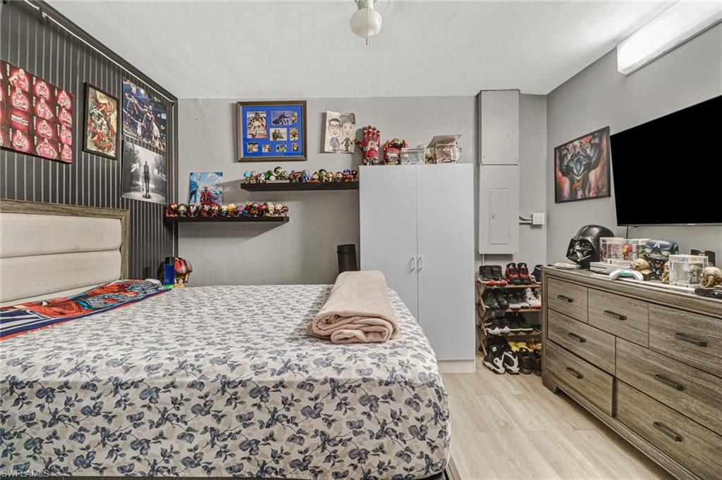 2329 41st Terrace Southwest Naples, FL 34116 - Photo 14 of 33 a bedroom with a bed and a flat screen tv