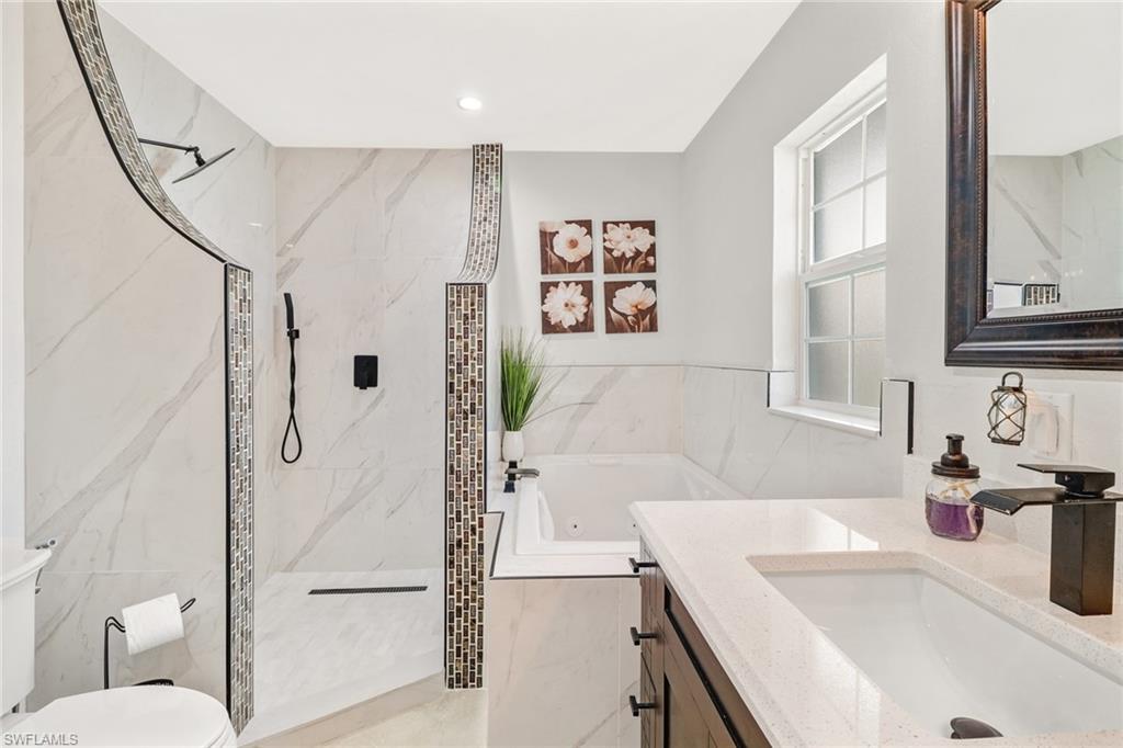 2329 41st Terrace Southwest Naples, FL 34116 - Photo 18 of 33 a bathroom with a sink a toilet and a bathtub