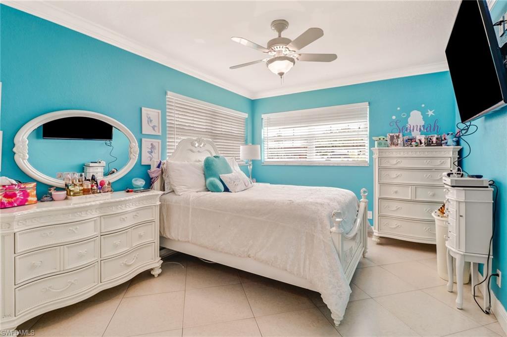 2329 41st Terrace Southwest Naples, FL 34116 - Photo 19 of 33 a bedroom with a bed and a flat screen tv