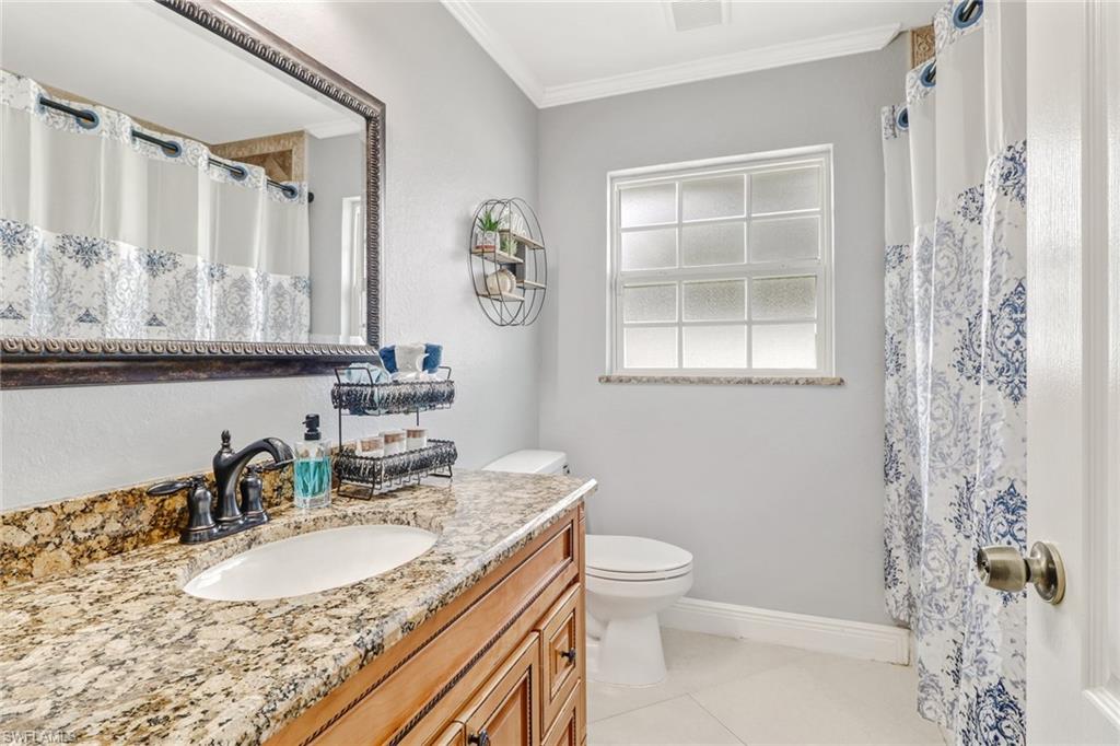 2329 41st Terrace Southwest Naples, FL 34116 - Photo 20 of 33 a bathroom with a granite countertop sink toilet and shower