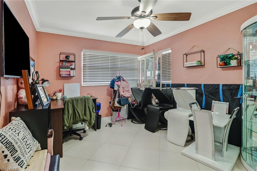 2329 41st Terrace Southwest Naples, FL 34116 - Photo 21 of 33 a living room with furniture a flat screen tv and a window