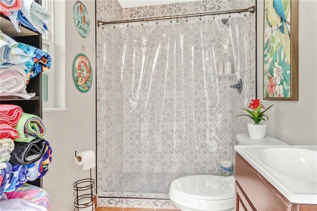 2329 41st Terrace Southwest Naples, FL 34116 - Photo 22 of 33 a bathroom with a sink a toilet and shower curtain