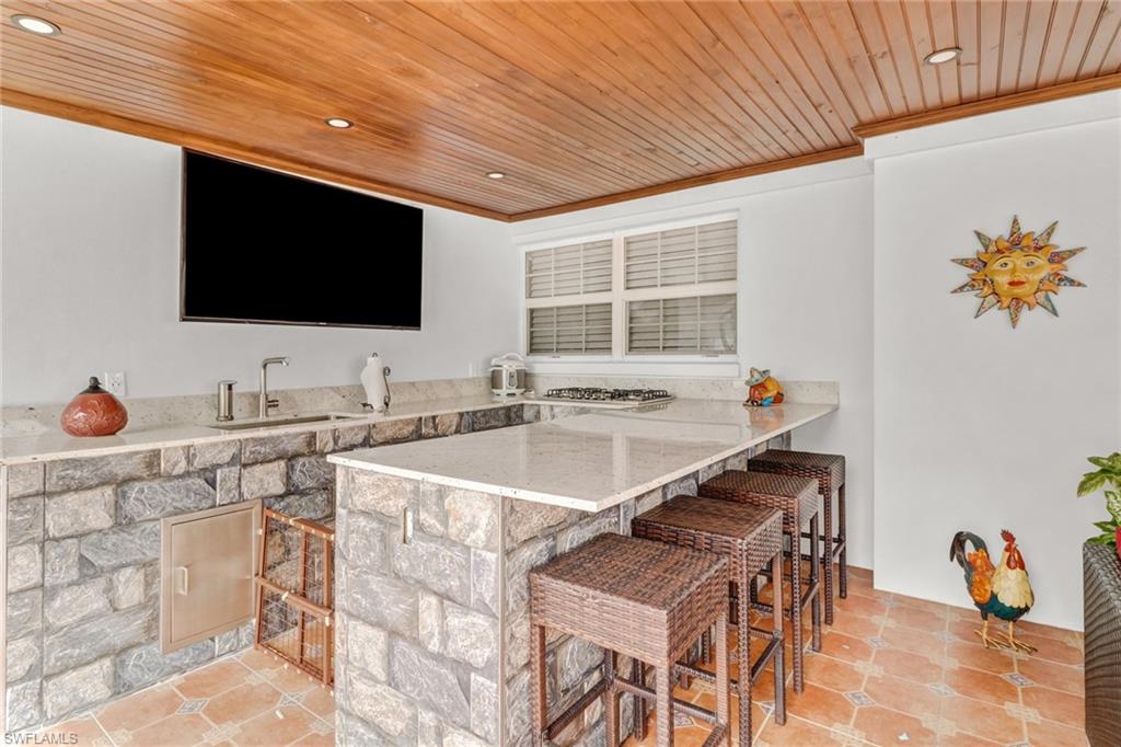 2329 41st Terrace Southwest Naples, FL 34116 - Photo 25 of 33 a view of a kitchen with a sink and a microwave