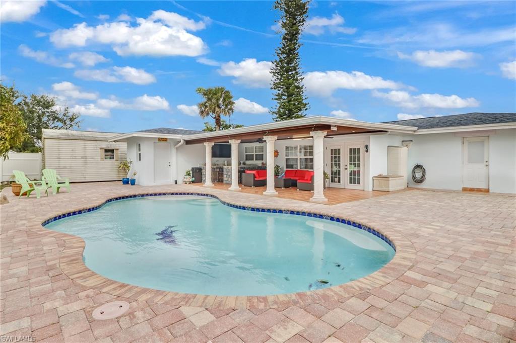 2329 41st Terrace Southwest Naples, FL 34116 - Photo 29 of 33 a view of swimming pool with outdoor seating