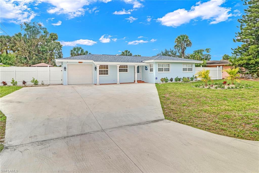 2329 41st Terrace Southwest Naples, FL 34116 - Photo 3 of 33 a view of a house with a yard and potted plants