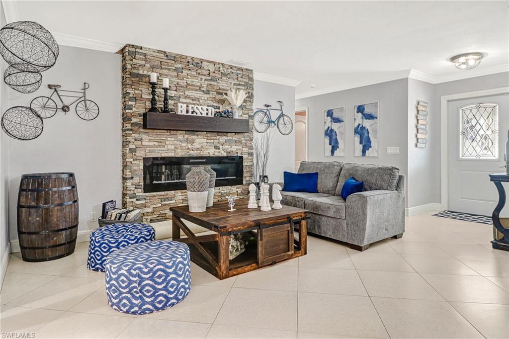 2329 41st Terrace Southwest Naples, FL 34116 - Photo 4 of 33 a living room with furniture and a fireplace