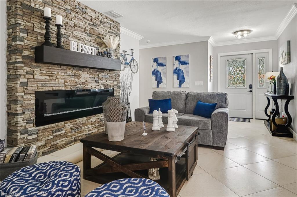 2329 41st Terrace Southwest Naples, FL 34116 - Photo 5 of 33 a living room with furniture and a fireplace