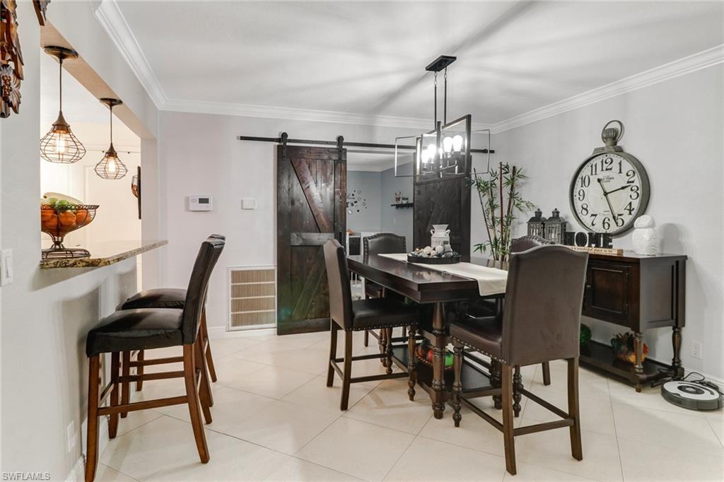 2329 41st Terrace Southwest Naples, FL 34116 - Photo 7 of 33 a view of a dining room with furniture window and wooden floor