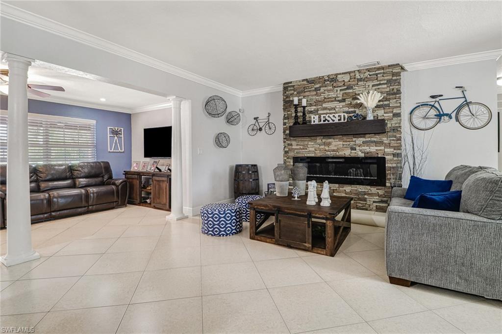 2329 41st Terrace Southwest Naples, FL 34116 - Photo 8 of 33 a living room with furniture and a fireplace