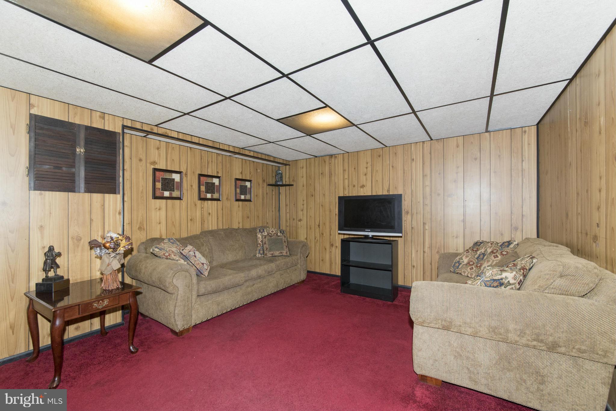 609 South Wickham Road Baltimore, MD 21229 - Photo 22 of 30 a living room with furniture and a flat screen tv