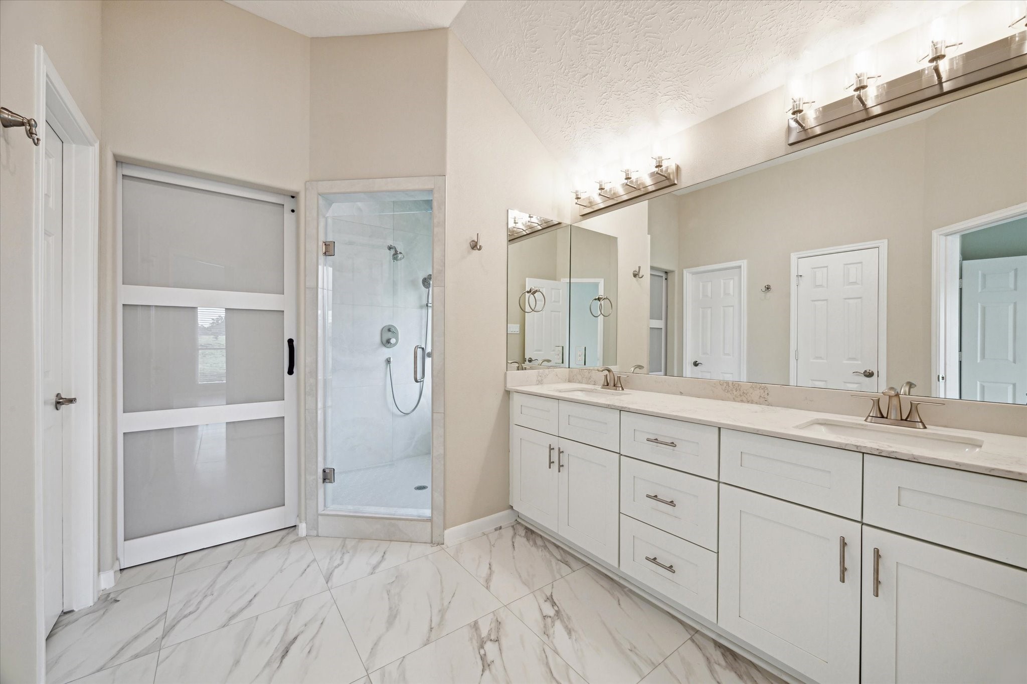 416 Twin Timbers Lane Kemah, TX 77565 - Photo 14 of 29 a spacious bathroom with a double vanity sink a shower and a mirror