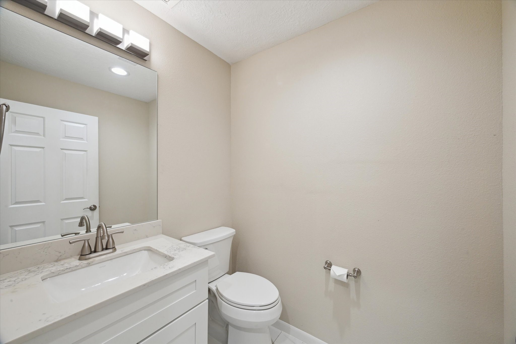 416 Twin Timbers Lane Kemah, TX 77565 - Photo 22 of 29 a bathroom with a granite countertop sink a toilet and a mirror