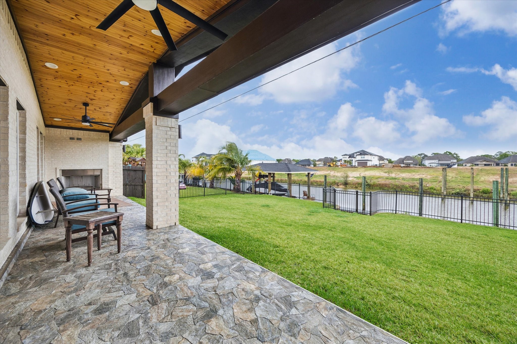 416 Twin Timbers Lane Kemah, TX 77565 - Photo 25 of 29 a view of a patio with a table chairs and a yard