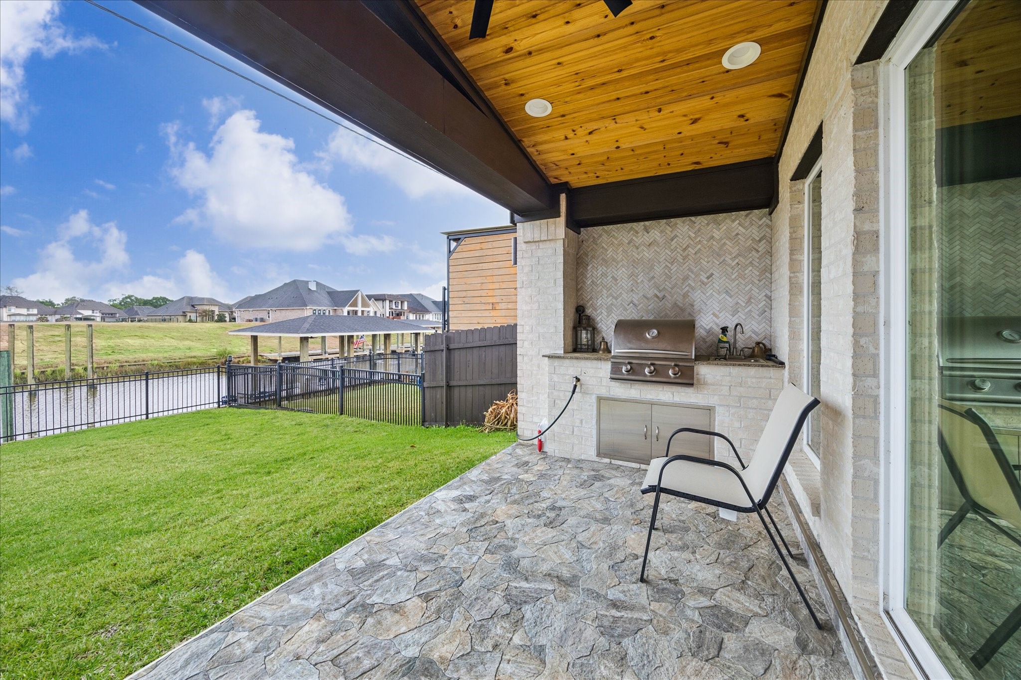 416 Twin Timbers Lane Kemah, TX 77565 - Photo 26 of 29 a view of a chairs and table in backyard