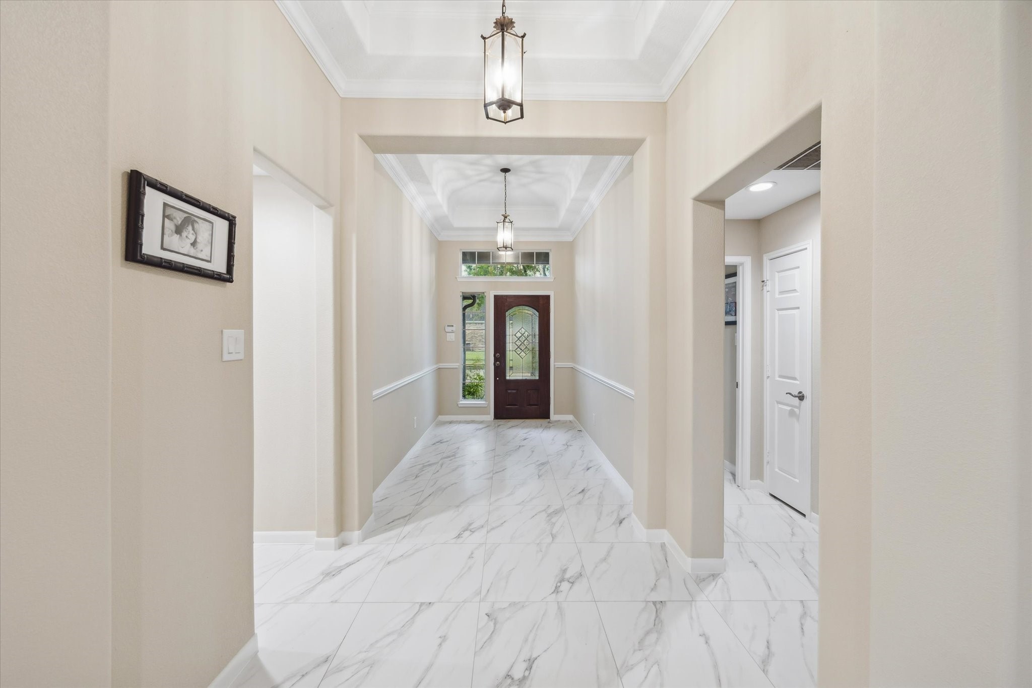 416 Twin Timbers Lane Kemah, TX 77565 - Photo 4 of 29 a view of a hallway with wooden floor and chandelier