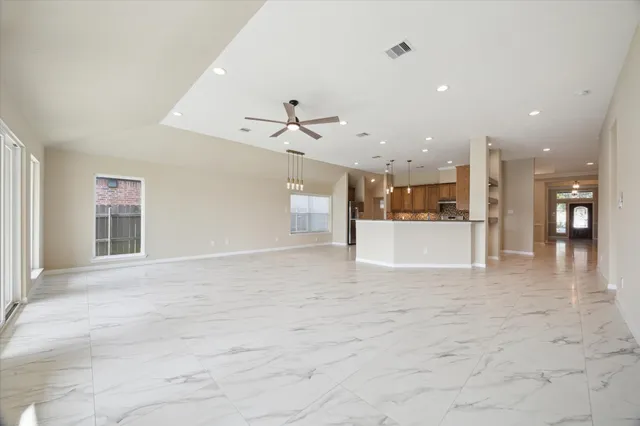 a view of a kitchen with a sink and a refrigerator