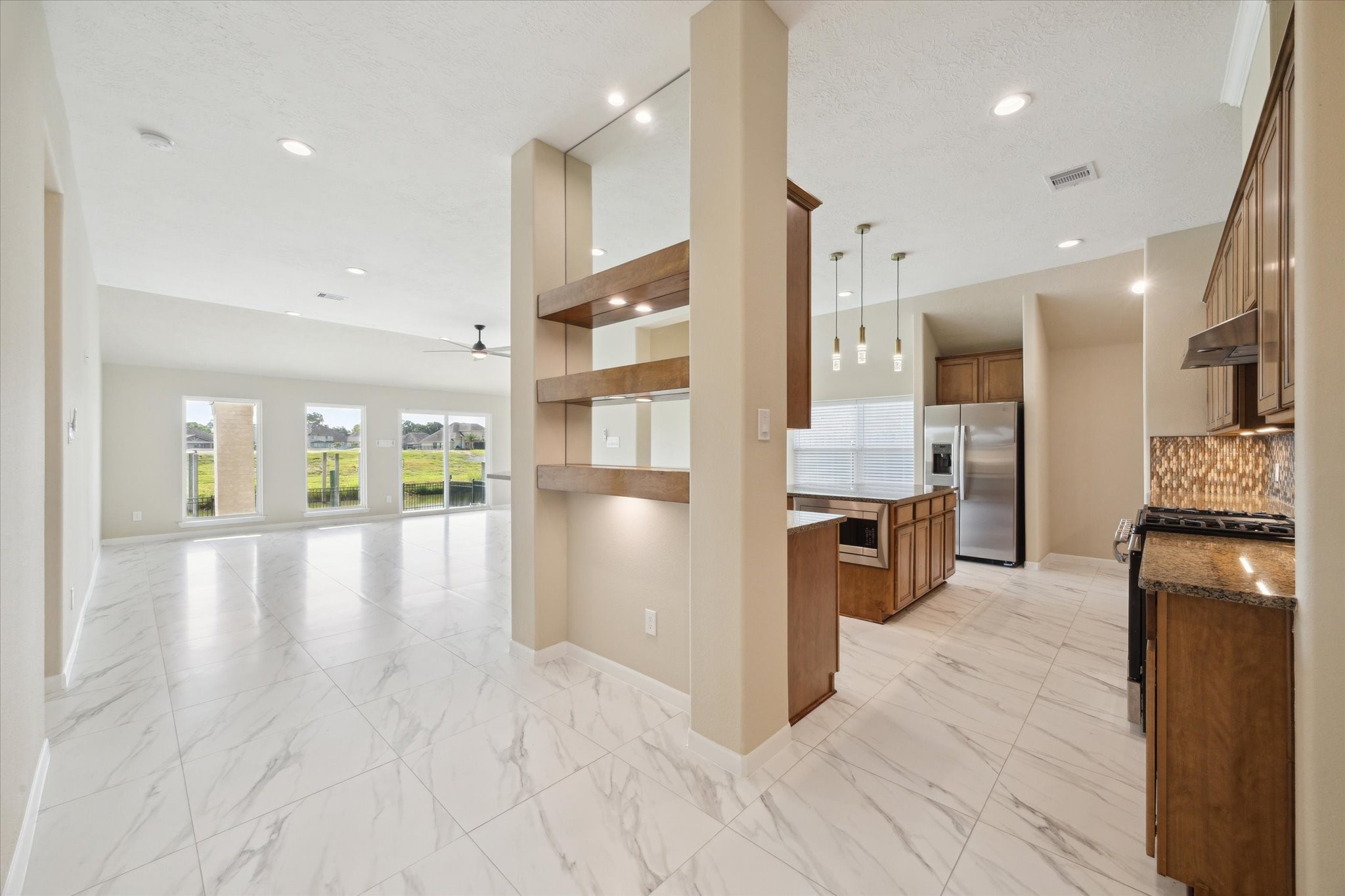 416 Twin Timbers Lane Kemah, TX 77565 - Photo 8 of 29 a view of a kitchen with stainless steel appliances granite countertop a refrigerator a sink dishwasher and a stove with wooden floor
