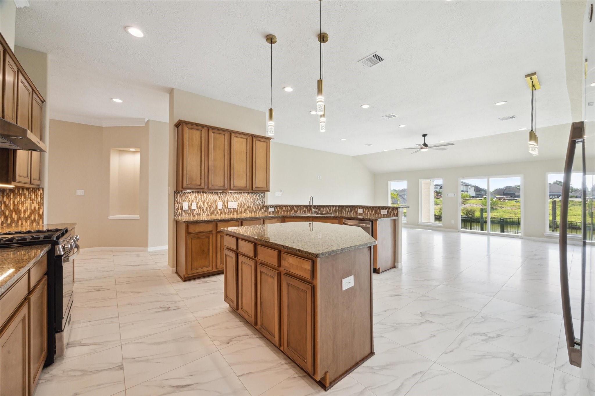 416 Twin Timbers Lane Kemah, TX 77565 - Photo 10 of 29 a kitchen with kitchen island granite countertop a stove and a sink