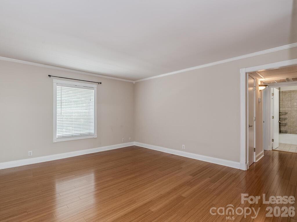 2600 Park Road, Unit D Charlotte, NC 28209 - Photo 11 of 22 a view of an empty room with wooden floor and a window