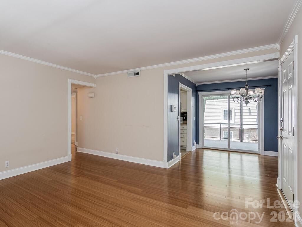 2600 Park Road, Unit D Charlotte, NC 28209 - Photo 12 of 22 a view of an empty room with wooden floor and a window