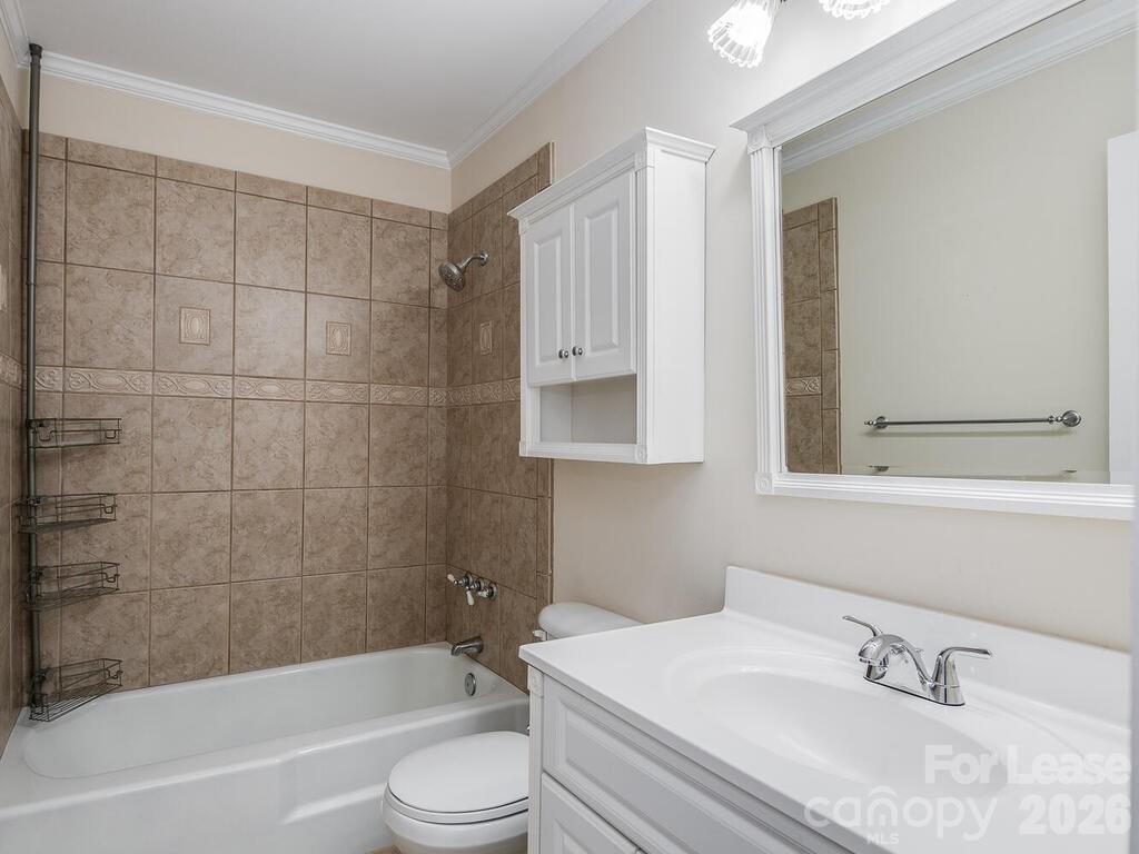 2600 Park Road, Unit D Charlotte, NC 28209 - Photo 15 of 22 a bathroom with a bathtub shower sink vanity and toilet