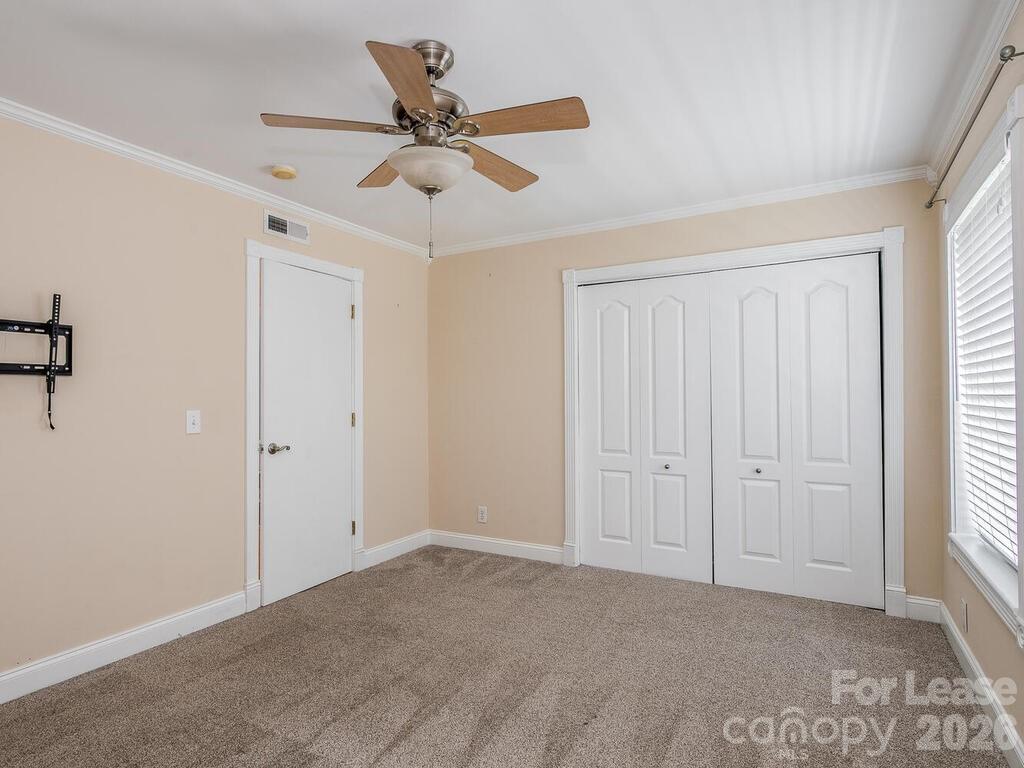 2600 Park Road, Unit D Charlotte, NC 28209 - Photo 17 of 22 a view of a livingroom with a ceiling fan and window