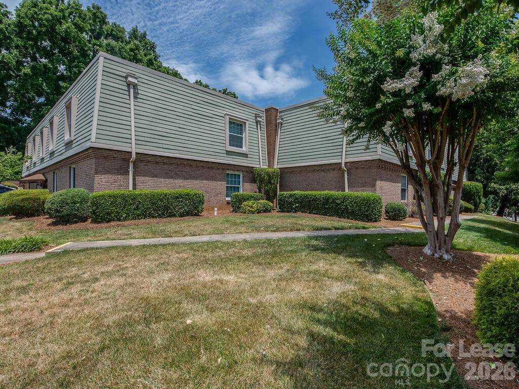 2600 Park Road, Unit D Charlotte, NC 28209 - Photo 2 of 22 a view of a house with yard and a garden