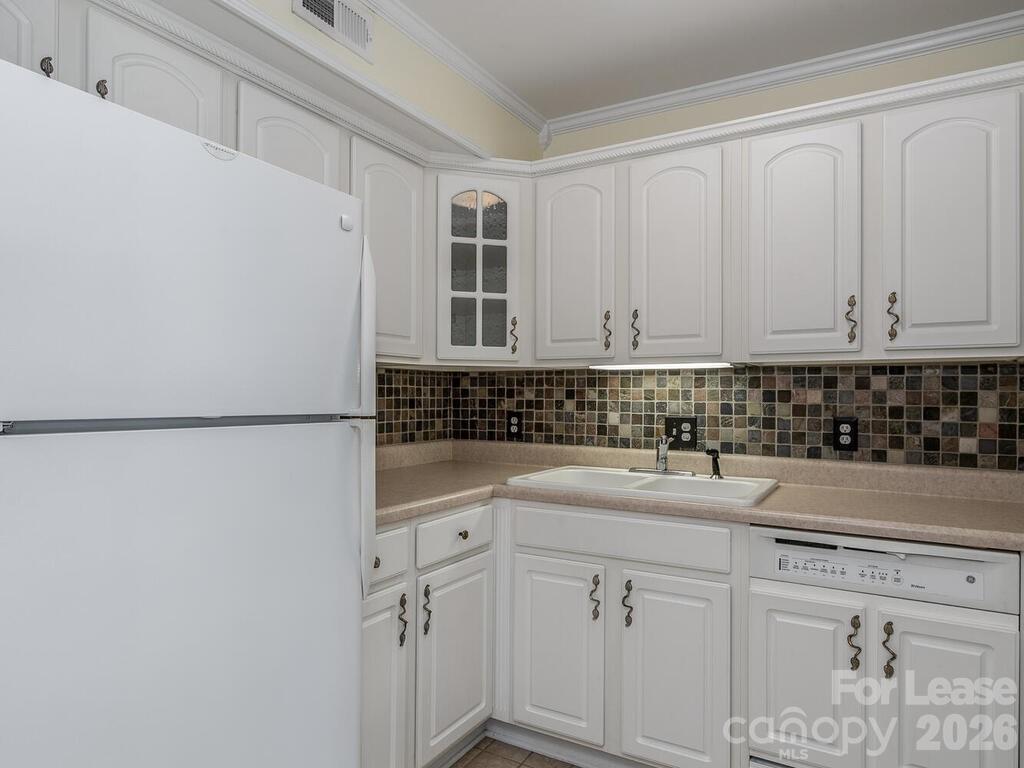2600 Park Road, Unit D Charlotte, NC 28209 - Photo 9 of 22 a kitchen with white cabinets and sink