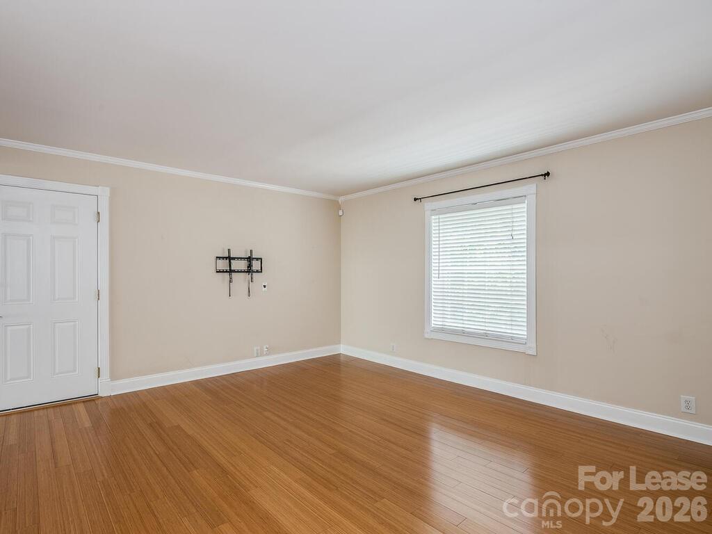 2600 Park Road, Unit D Charlotte, NC 28209 - Photo 10 of 22 an empty room with wooden floor and windows