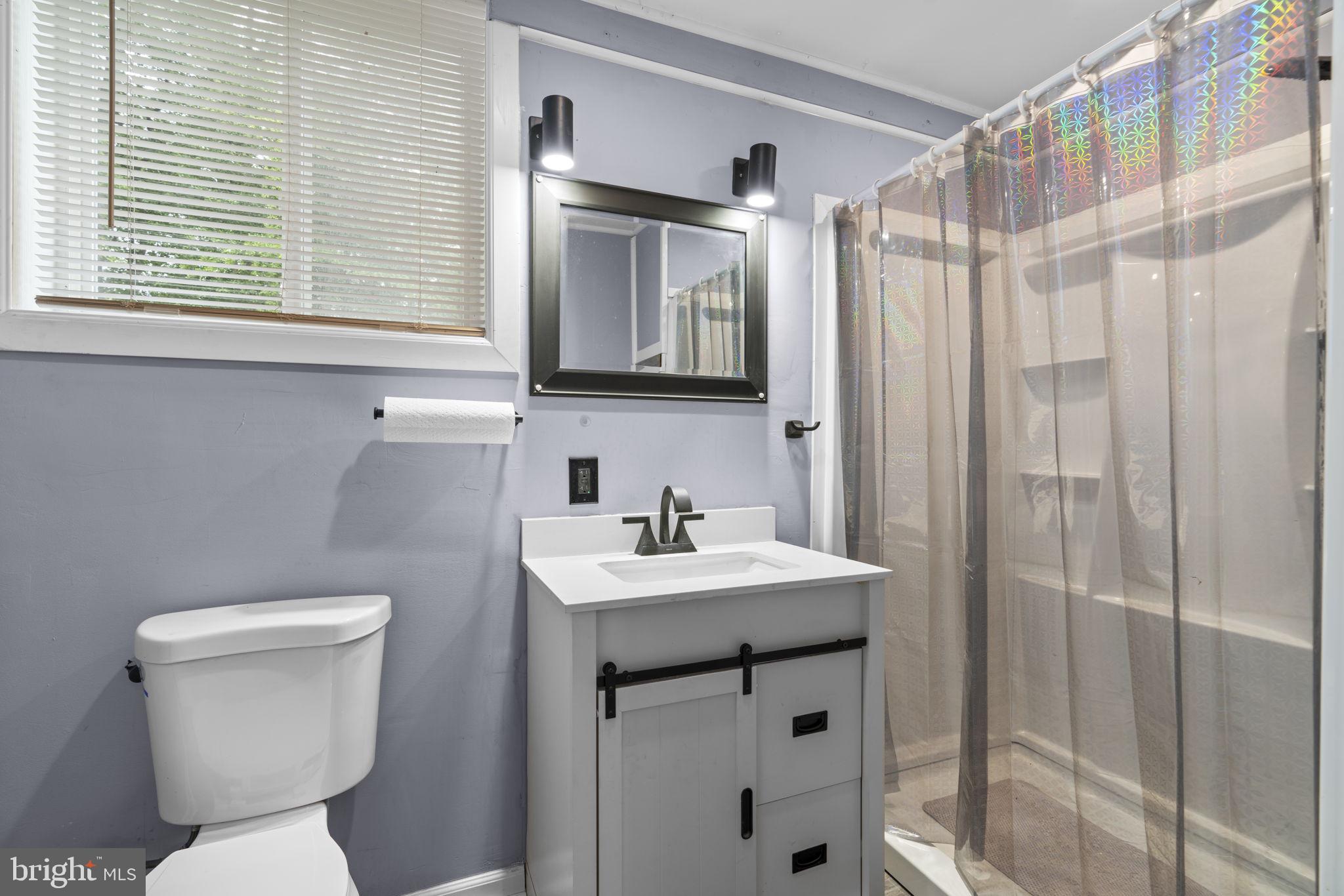 8024 Solley Road Glen Burnie, MD 21060 - Photo 77 of 83 a bathroom with a sink toilet and shower