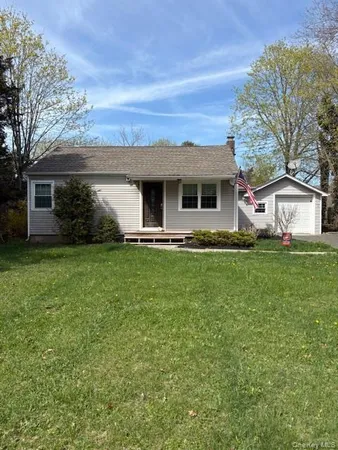 a front view of house with yard and green space