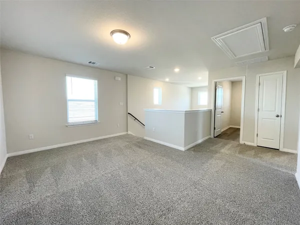 an empty room with a empty space and windows