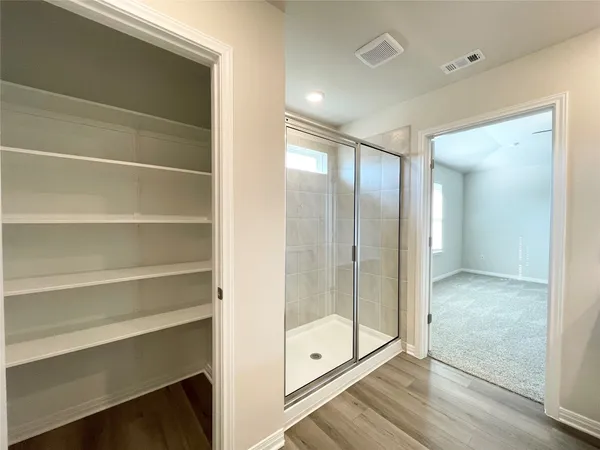 a bathroom with a glass shower door
