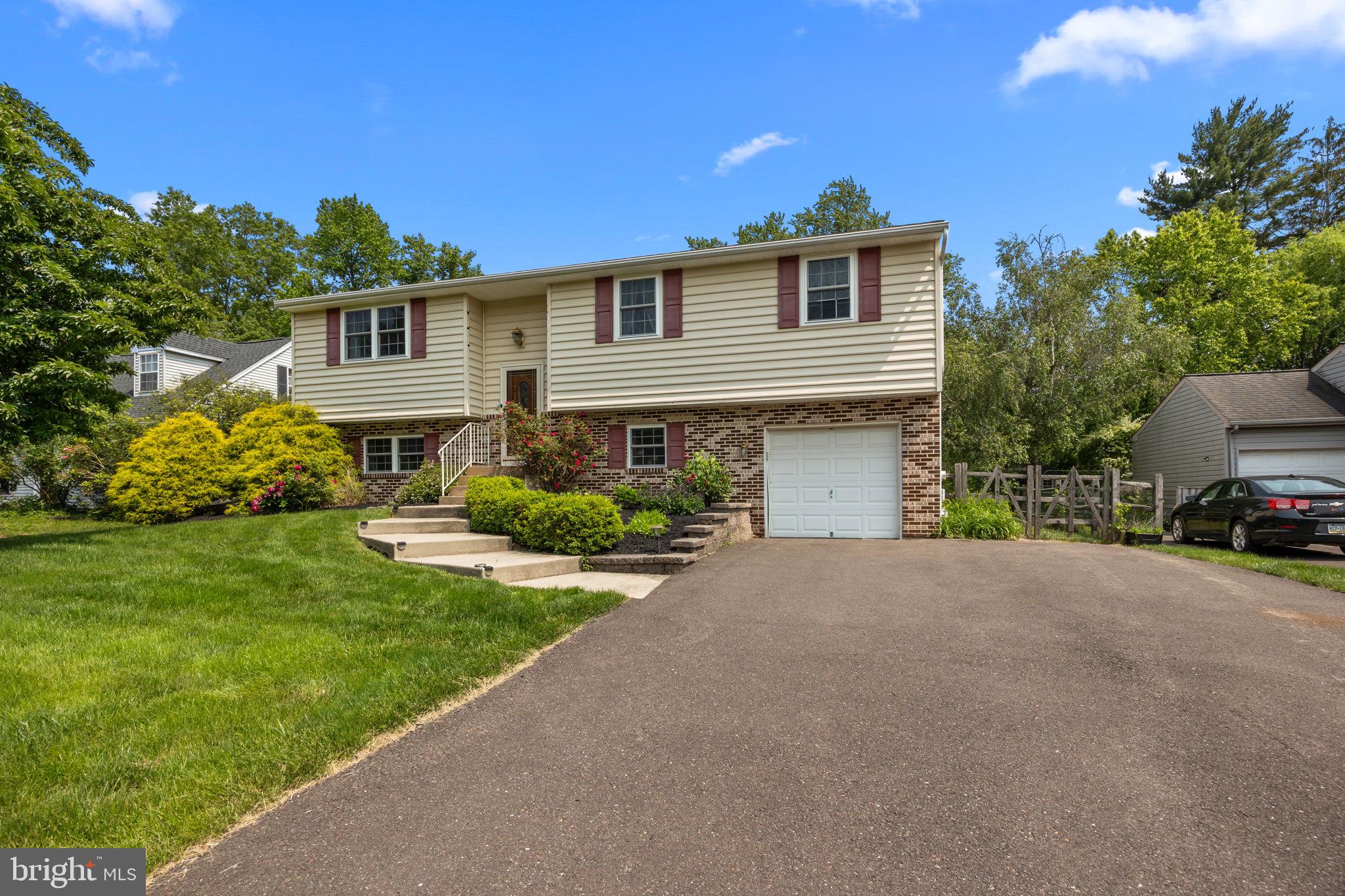 320 Pheasant Run Drive Doylestown, PA 18901 - Photo 31 of 47 a front view of a house with a garden and yard