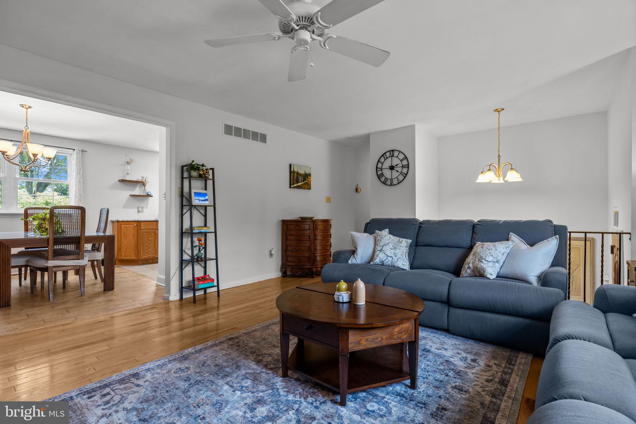 320 Pheasant Run Drive Doylestown, PA 18901 - Photo 8 of 47 a living room with furniture and a dining table with wooden floor