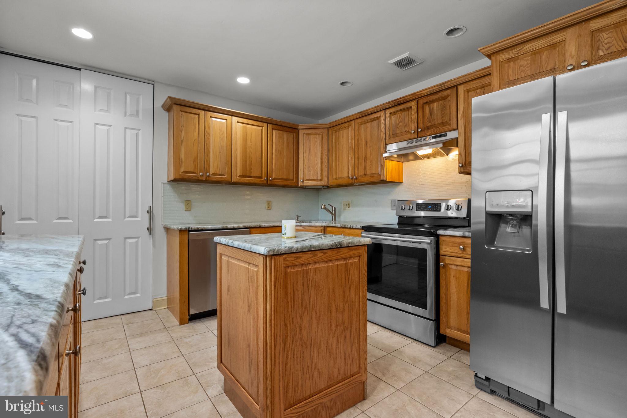 320 Pheasant Run Drive Doylestown, PA 18901 - Photo 9 of 47 a kitchen with a refrigerator sink and cabinets