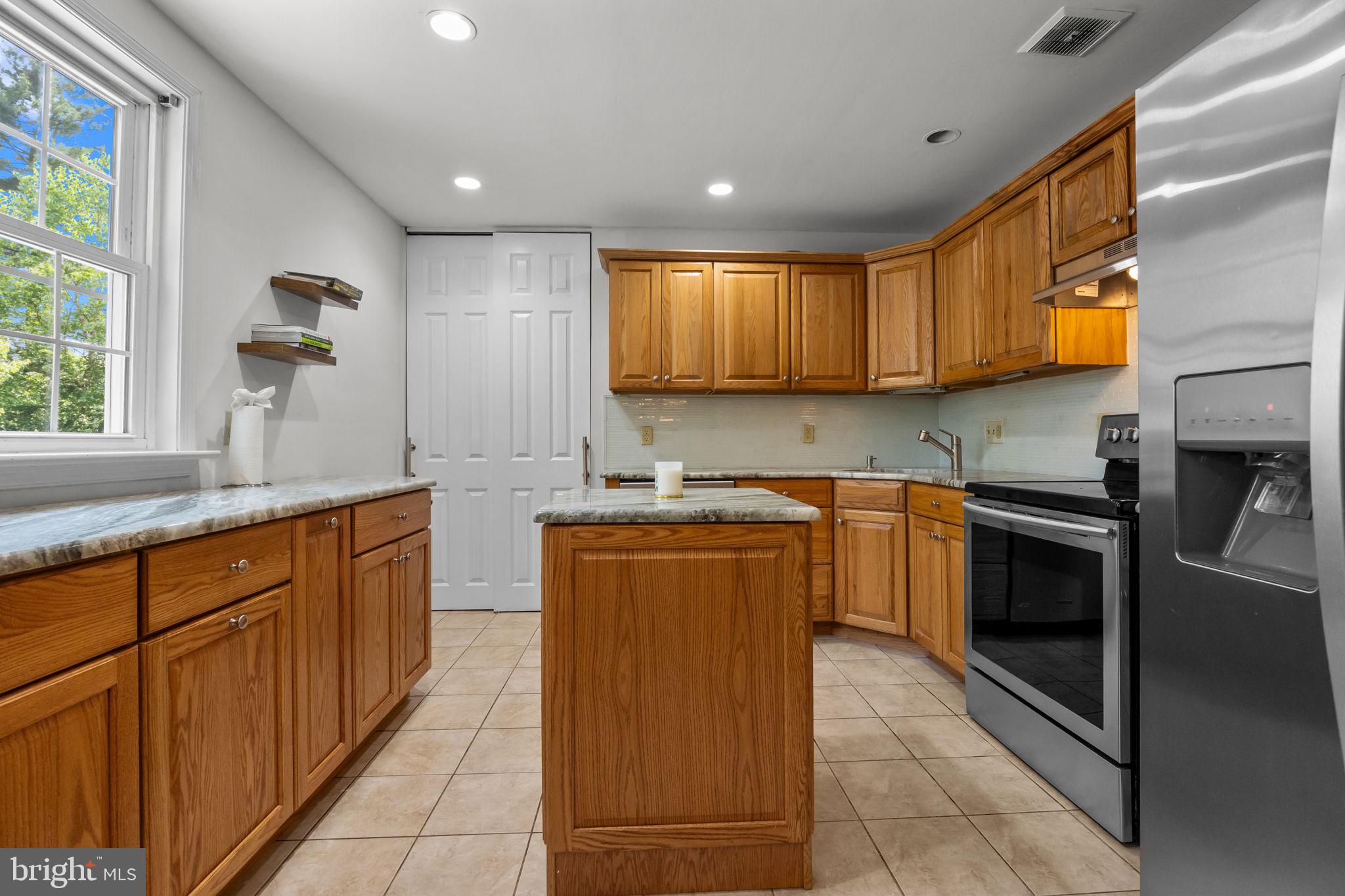 320 Pheasant Run Drive Doylestown, PA 18901 - Photo 10 of 47 a kitchen with stainless steel appliances granite countertop wooden cabinets a sink and a stove