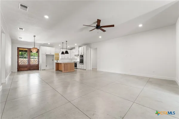 a view of a kitchen with a stove and a window